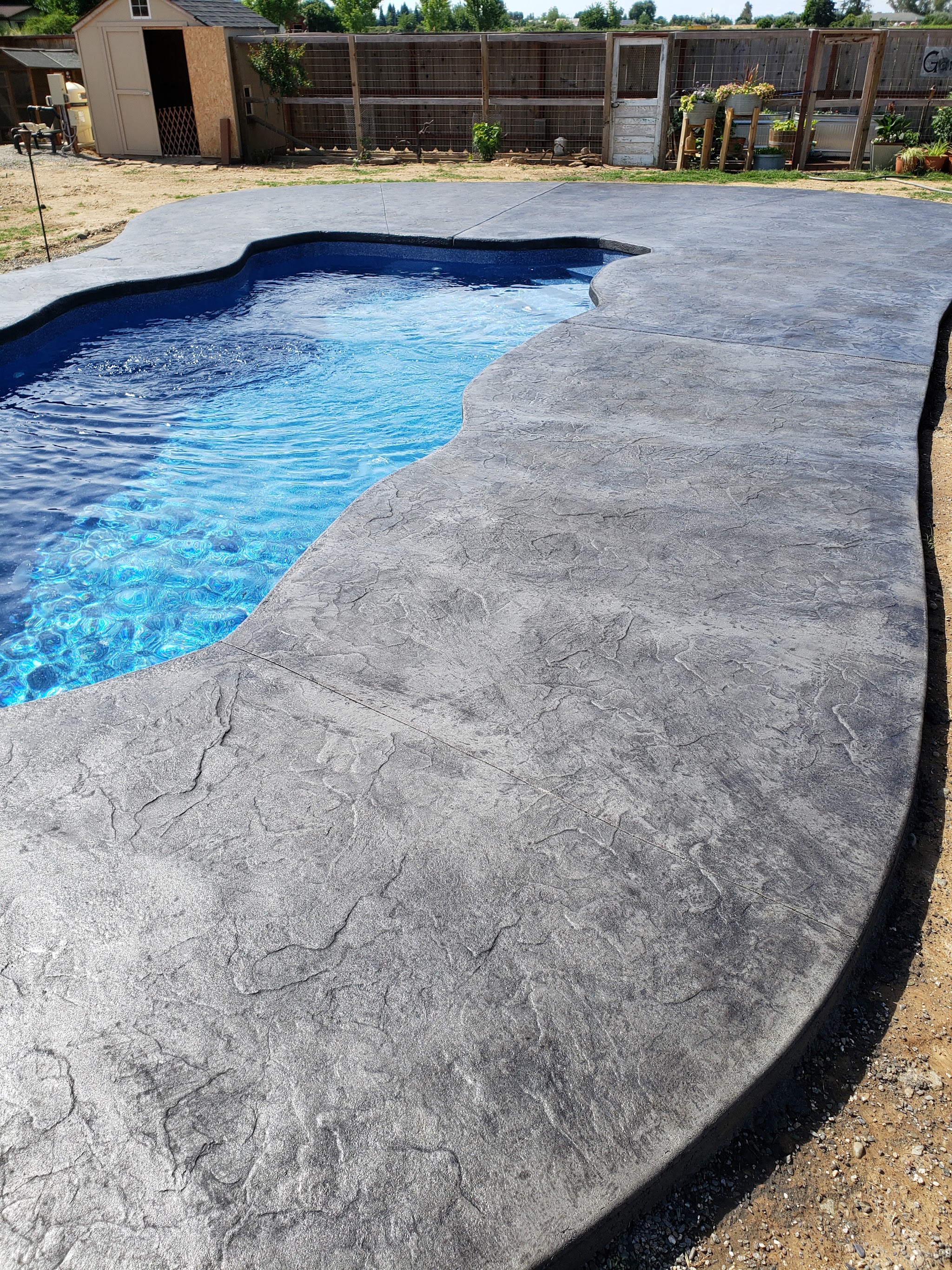 Color-stamped concrete pool deck by Williams Custom Concrete in Susanville